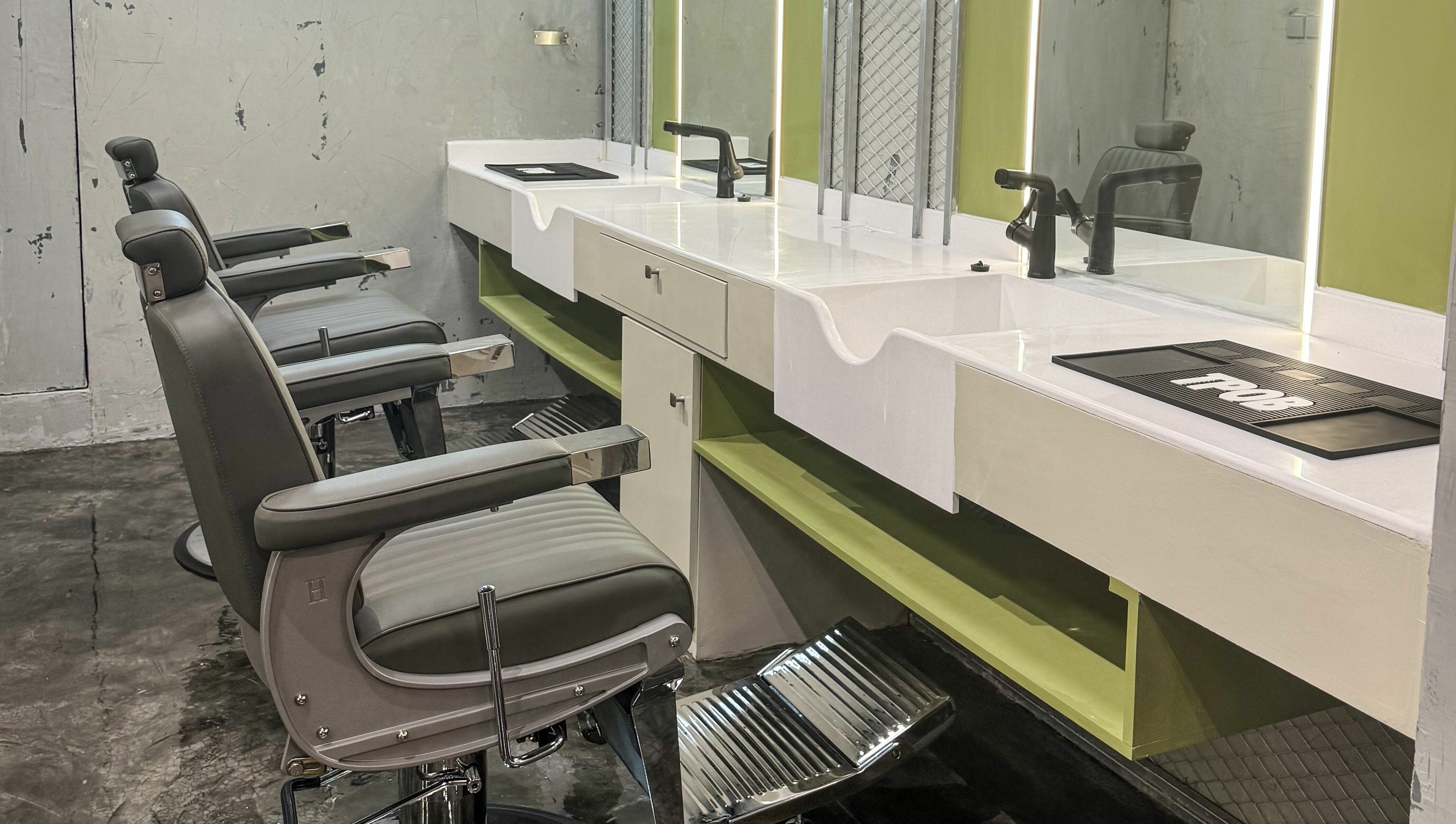 Elegant barber chairs at GOAT Barber, Muscat, Muscat Governorate, OM, showcasing modern interior and design.