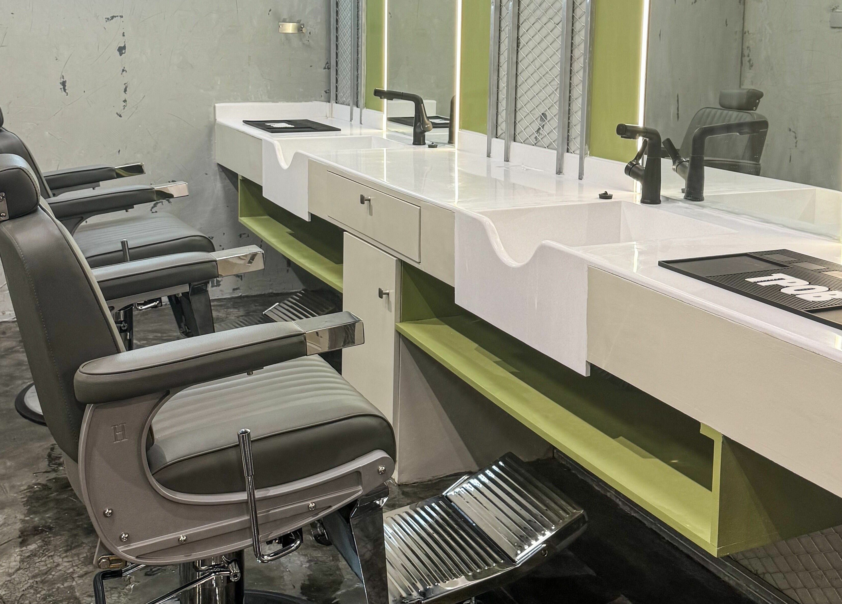 Elegant barber chairs at GOAT Barber, Muscat, Muscat Governorate, OM, showcasing modern interior and design.