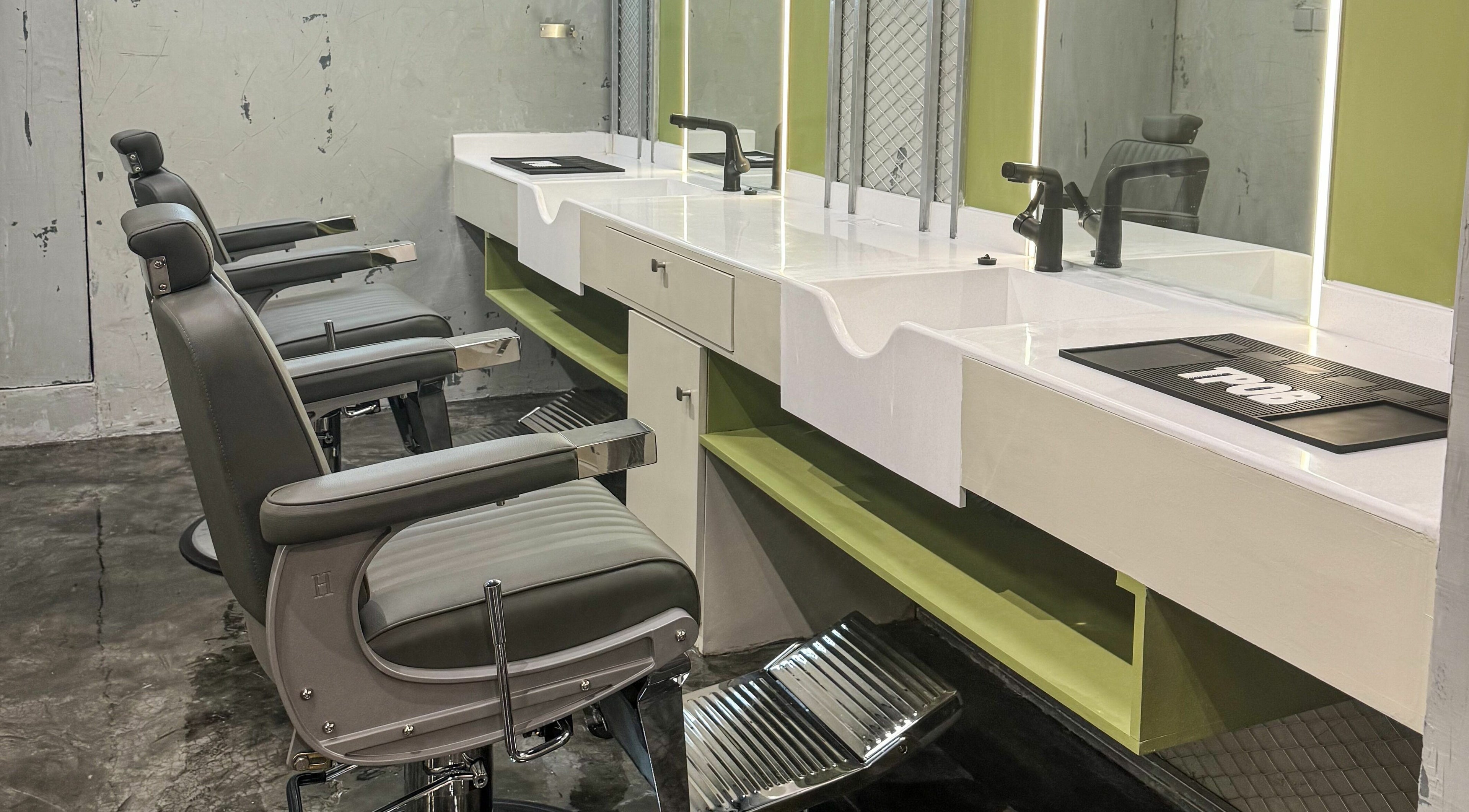 Elegant barber chairs at GOAT Barber, Muscat, Muscat Governorate, OM, showcasing modern interior and design.