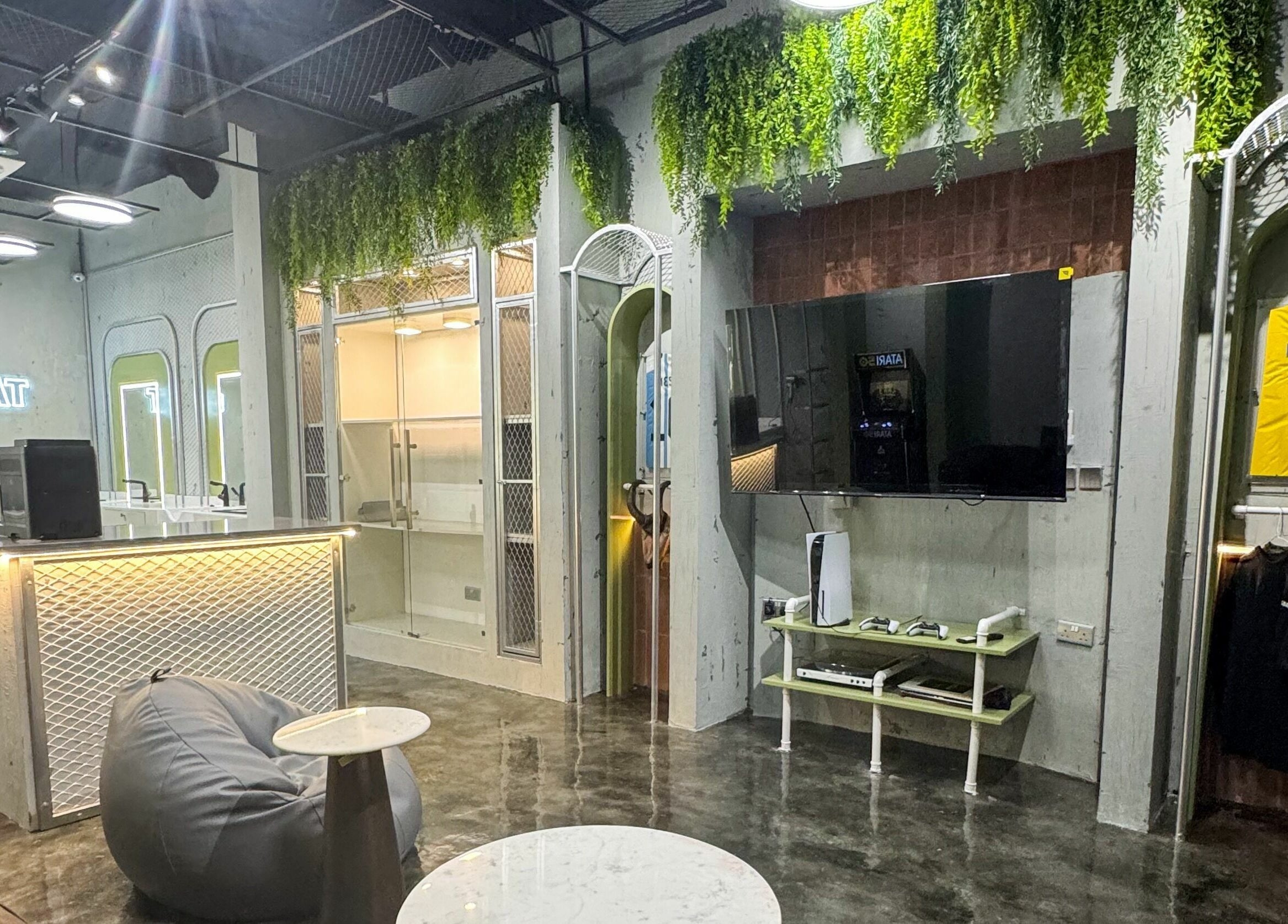 Modern interior of GOAT Barber in Muscat, Muscat Governorate, OM, featuring sleek decor and comfortable seating.