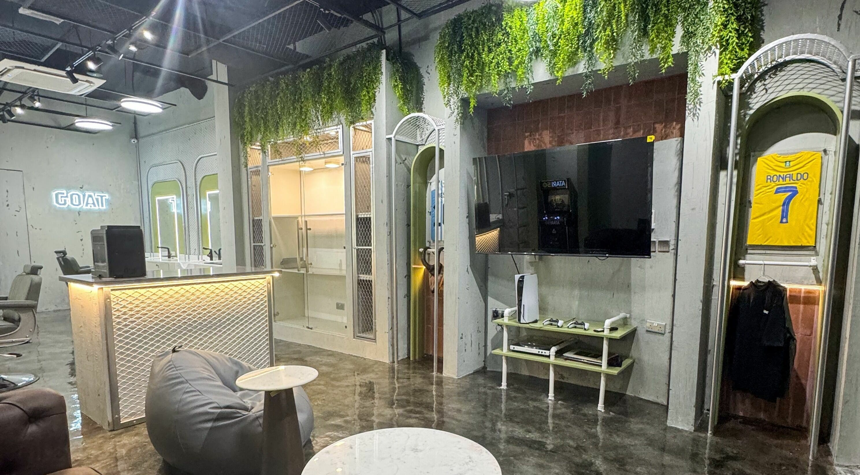 Modern interior of GOAT Barber in Muscat, Muscat Governorate, OM, featuring sleek decor and comfortable seating.