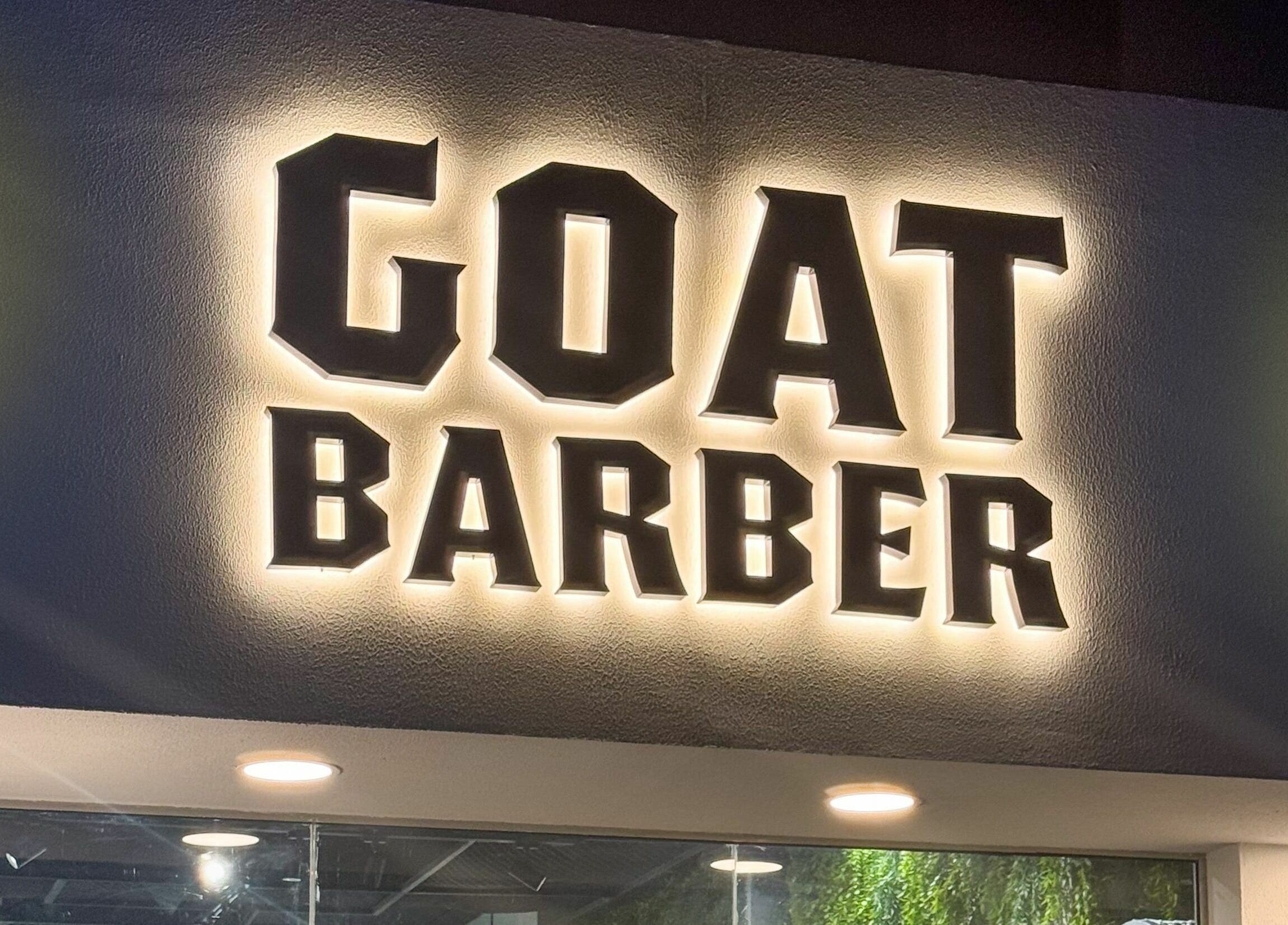 Illuminated GOAT Barber sign at Muscat, Muscat Governorate, OM, showcasing distinctive branding.