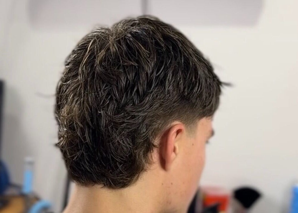 Modern haircut at Scully’s Barbershop in Clarkson, Western Australia, AU, featuring a tapered style.