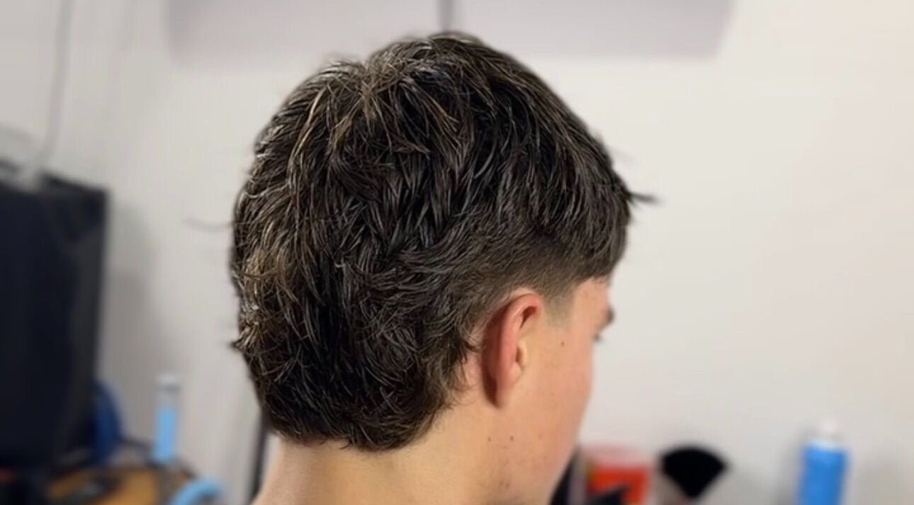 Modern haircut at Scully’s Barbershop in Clarkson, Western Australia, AU, featuring a tapered style.