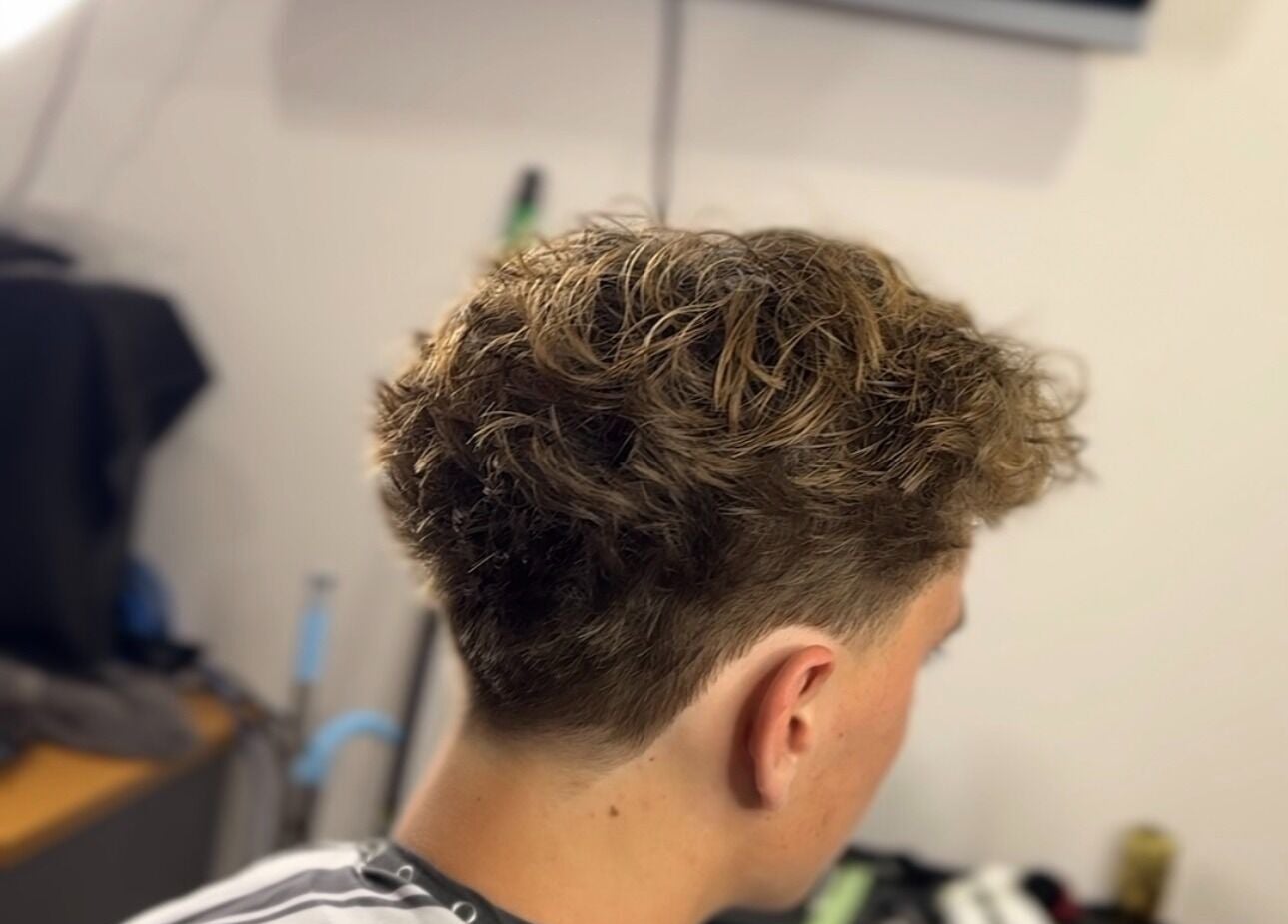 Stylish curly fade haircut from Scully’s Barbershop in Clarkson, Western Australia, AU.