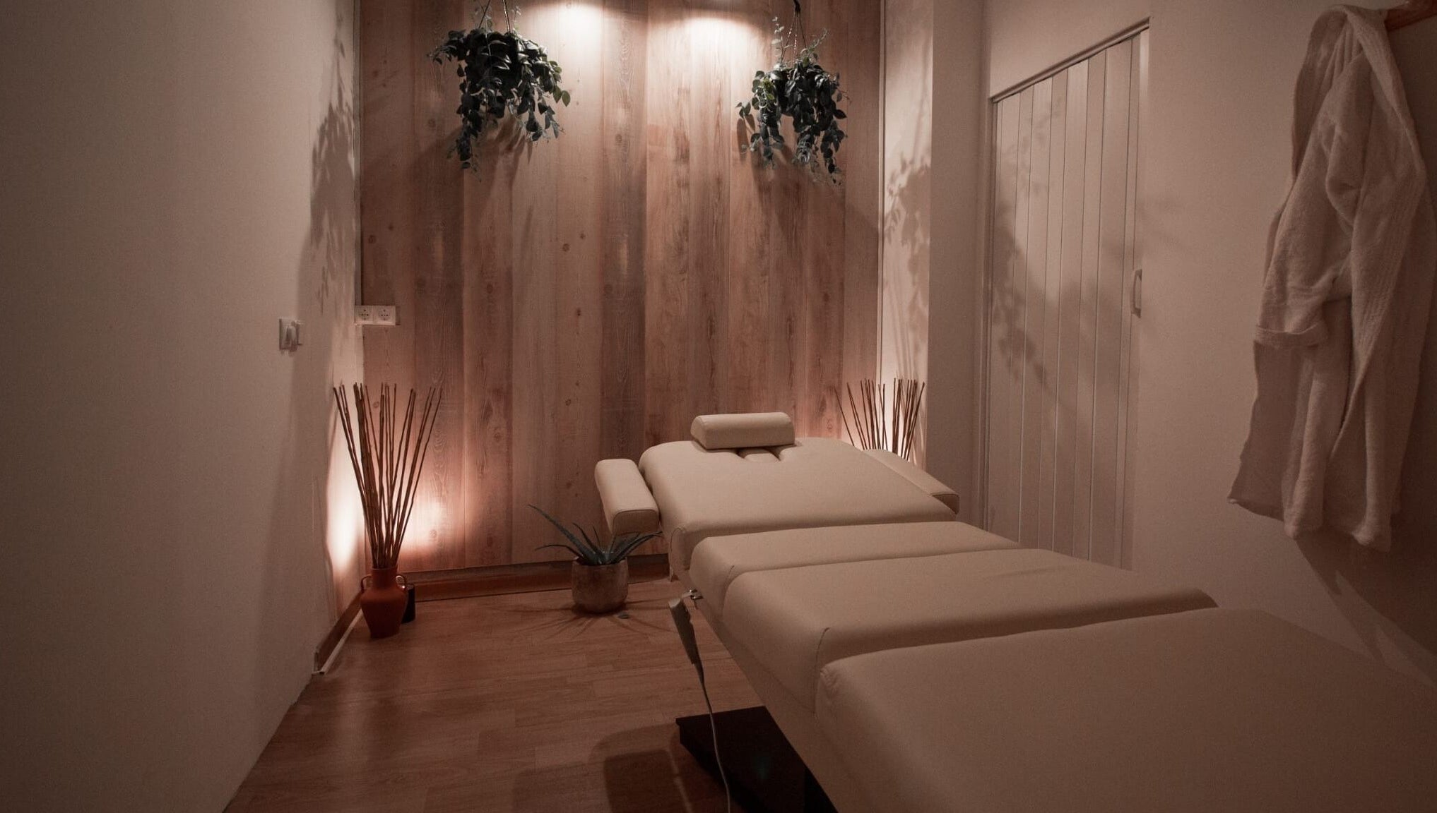 Sala de tratamiento en Mímate Estética Avanzada, Torredembarra, Catalunya, ES con cama de masaje y decoración serena.