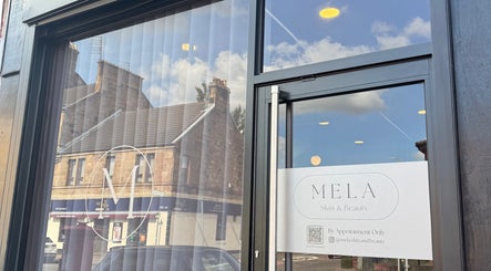 Front entrance of Mela Skin & Beauty in Glasgow, Scotland, GB with modern glass design.