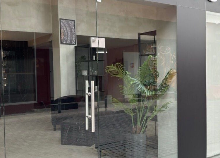 Entrance of Ink Story Tattoo in Larnaka, Larnaka, CY featuring modern glass doors and inviting decor.
