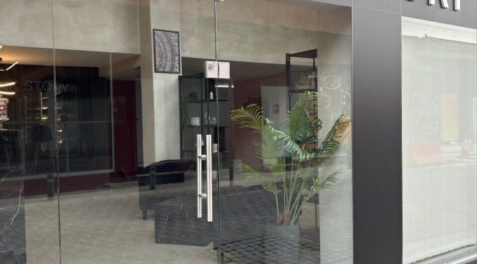 Entrance of Ink Story Tattoo in Larnaka, Larnaka, CY featuring modern glass doors and inviting decor.