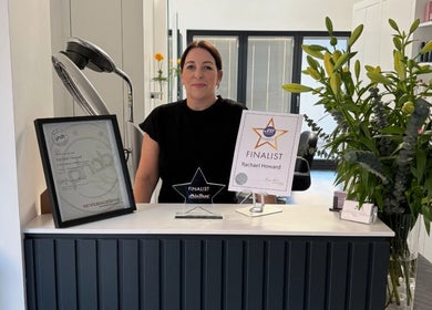 Reception desk at Beauty Within Durham featuring awards and decor, located in Durham, England, GB.