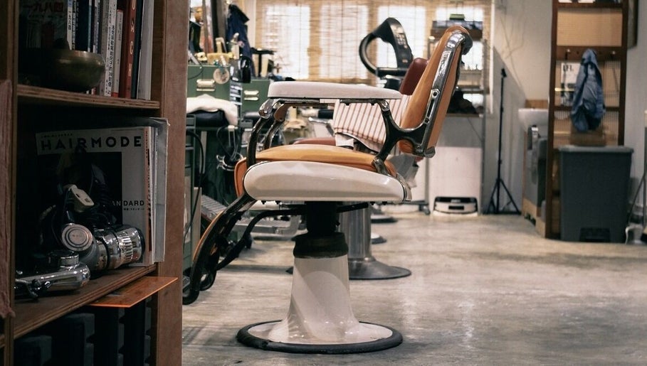 Vintage barber chair at Con Den Se Barber & Stylist, Hong Kong 香港, HK offering classic grooming.
