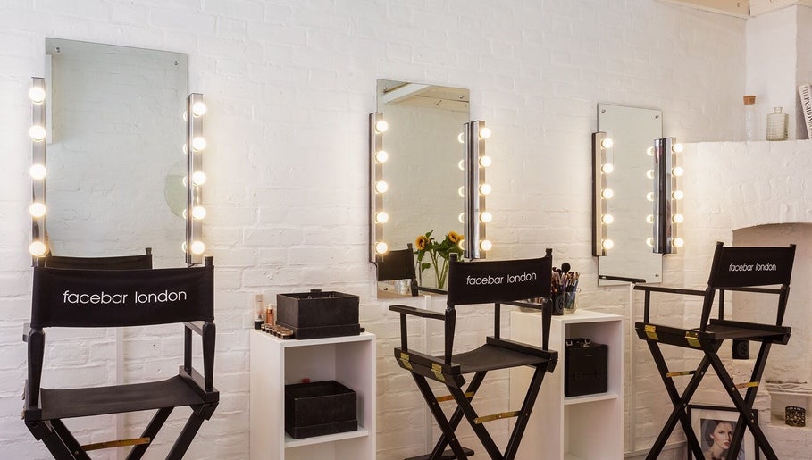 Facebar London makeup space with vanity mirrors and chairs in London, England, GB.