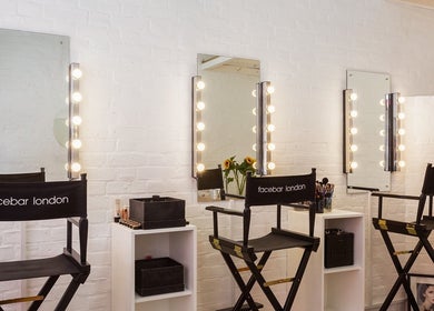 Facebar London makeup space with vanity mirrors and chairs in London, England, GB.