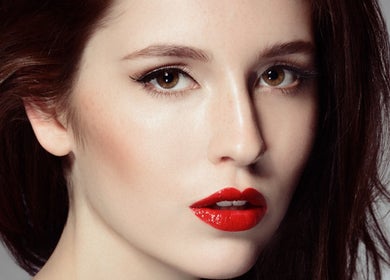 Close-up of a woman's makeup at Facebar London, London, England, GB featuring bold lipstick and flawless complexion.