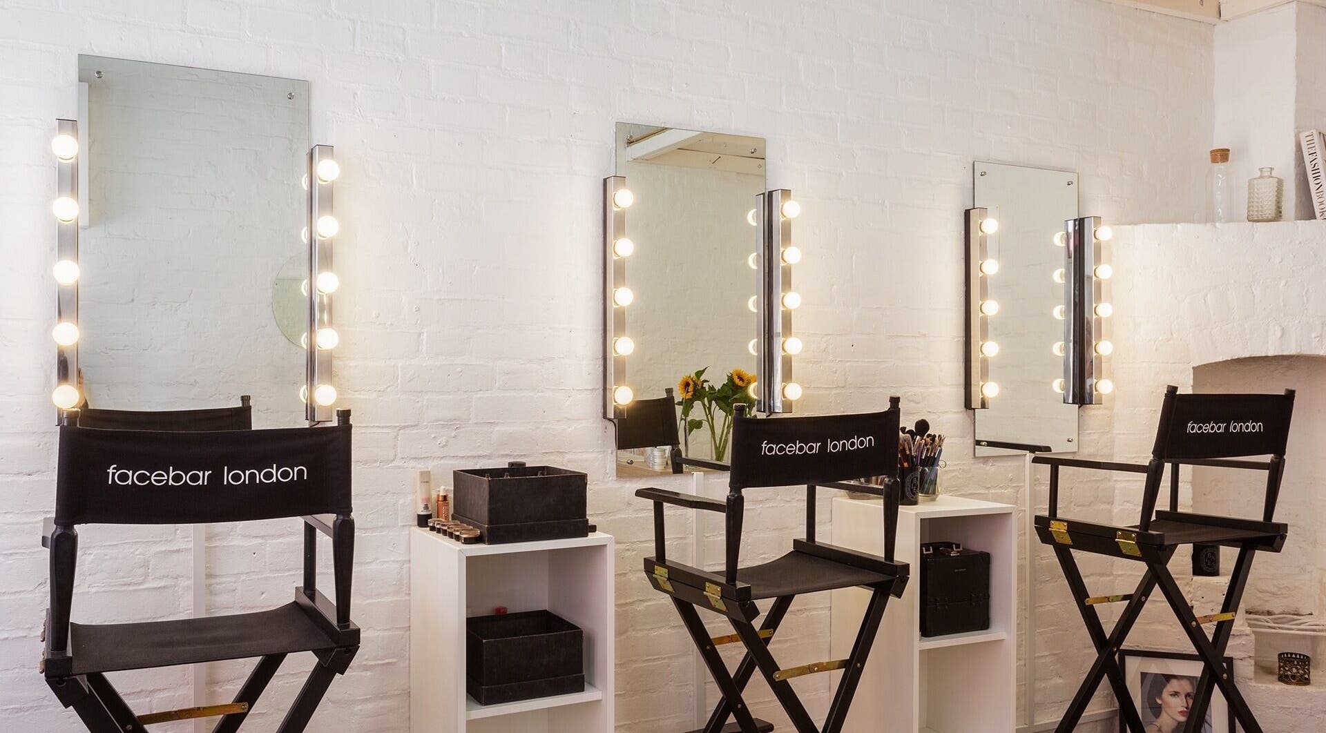 Facebar London makeup studio with lit mirrors and stylish chairs in London, England, GB.