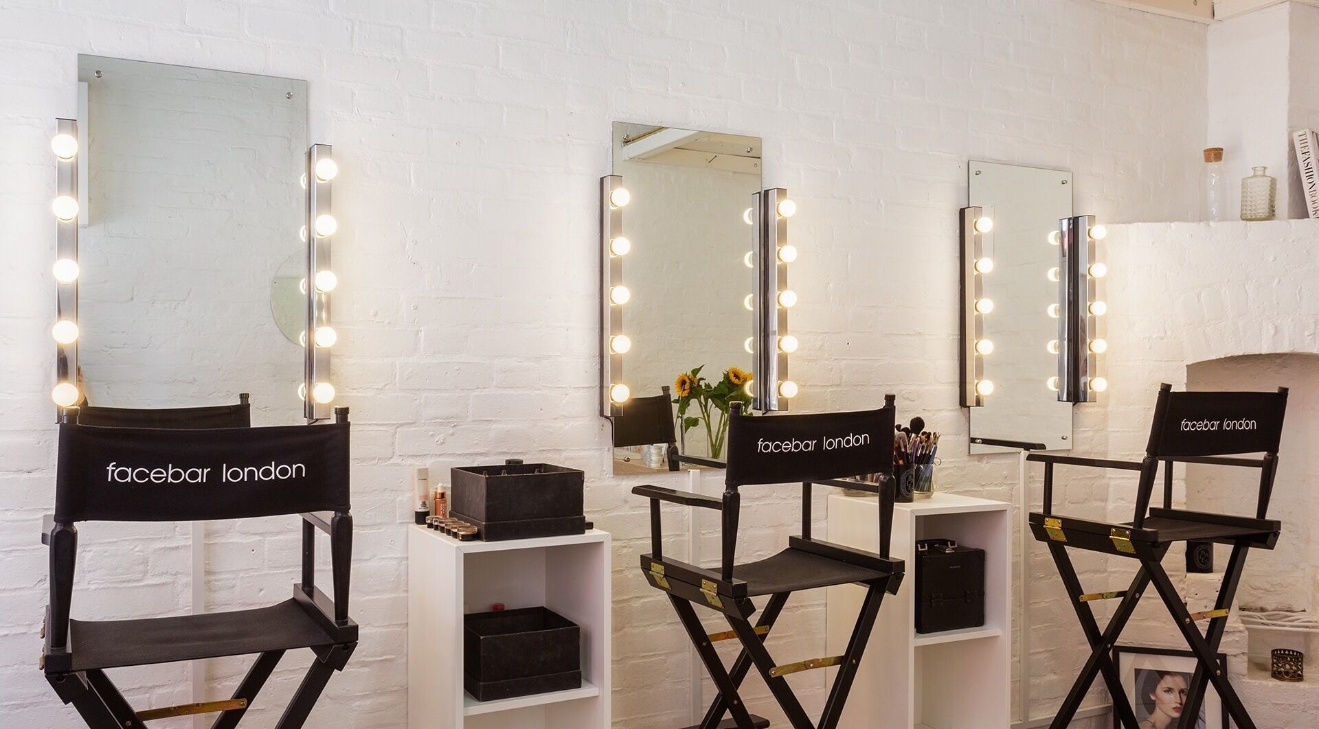 Facebar London makeup studio with lit mirrors and stylish chairs in London, England, GB.
