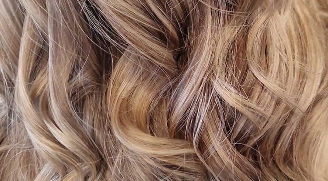 Close-up of lustrous curls styled by Hair by Catherine in Wimborne Minster, England, GB.