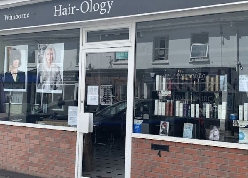 Exterior of Hair by Catherine in Wimborne Minster, England, GB, showcasing modern window displays.