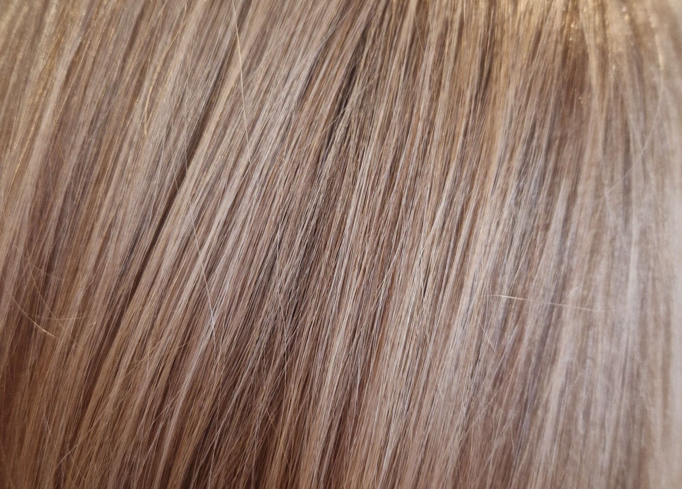 Close-up of sleek, shiny blonde hair at Hair by Catherine, Wimborne Minster, England, GB.