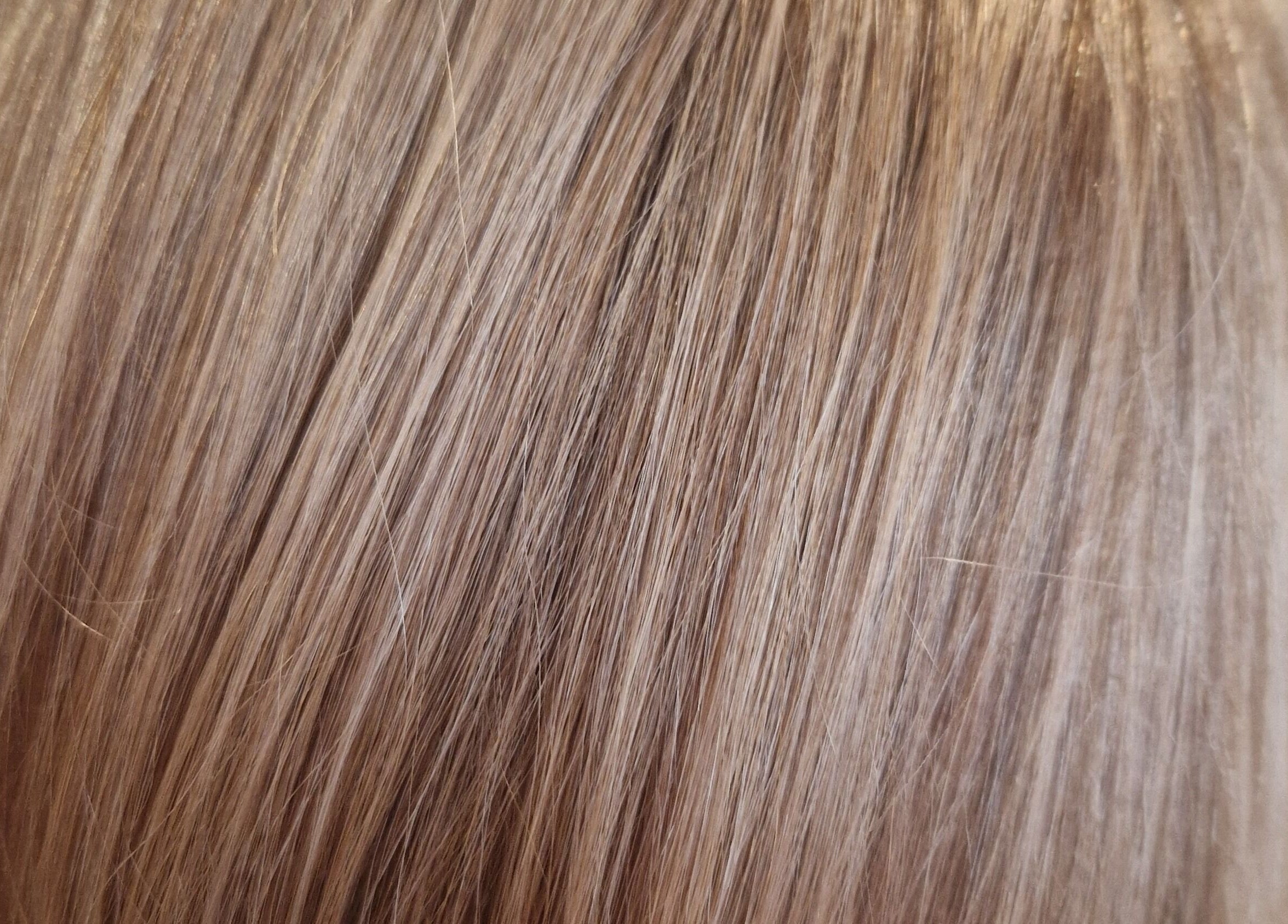 Close-up of sleek, shiny blonde hair at Hair by Catherine, Wimborne Minster, England, GB.