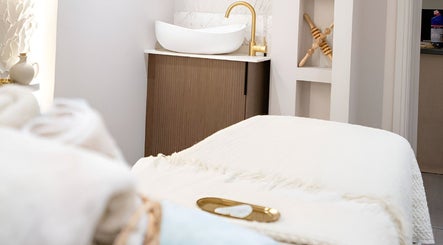 Luxurious treatment room at Lough Skin in Loughborough, England, GB, featuring a cozy massage table and elegant decor.