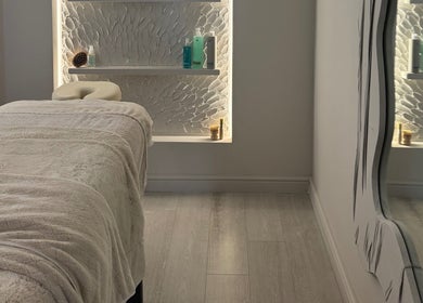 Relaxing treatment room at Lough Skin, Loughborough, England, GB with plush massage table and elegant decor.