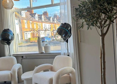 Comfortable salon chairs and dryers near a window at Lough Skin, Loughborough, England, GB.