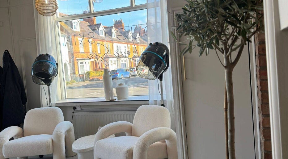 Relaxing chairs and hair dryers at Lough Skin, Loughborough, England, GB, creating a chic beauty experience.