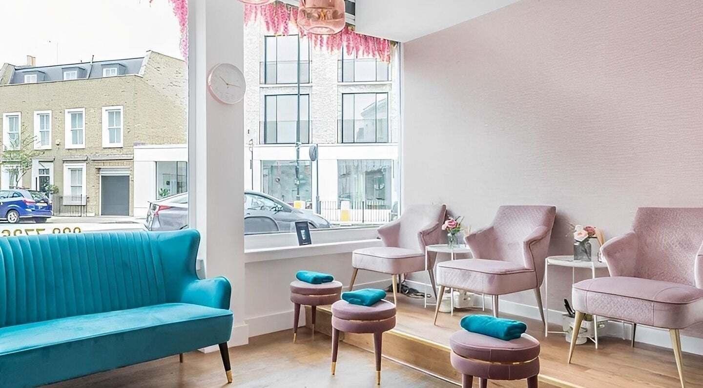 Elegant seating area at Poise Beauty Bar, London, England, GB with pastel decor and modern furnishings.