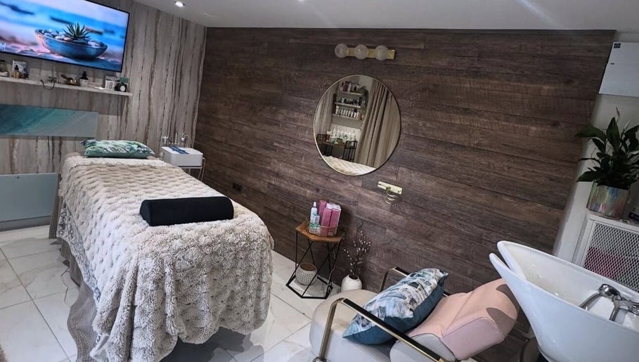 Relaxing treatment room at Green Ivy Skin and Spa, Kettering, England, GB with wood accents and plush decor.