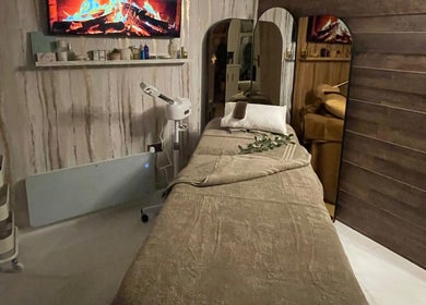 Relaxing treatment room at Green Ivy Skin and Spa, Kettering, England, GB, featuring a massage table and warm decor.