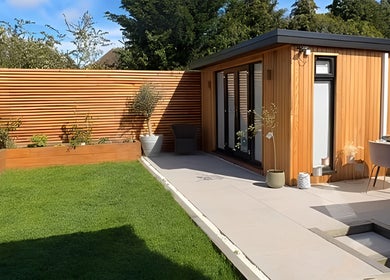 Serene garden at Green Ivy Skin and Spa in Kettering, England, GB. Wooden cabin, lush greenery, and relaxing ambience.