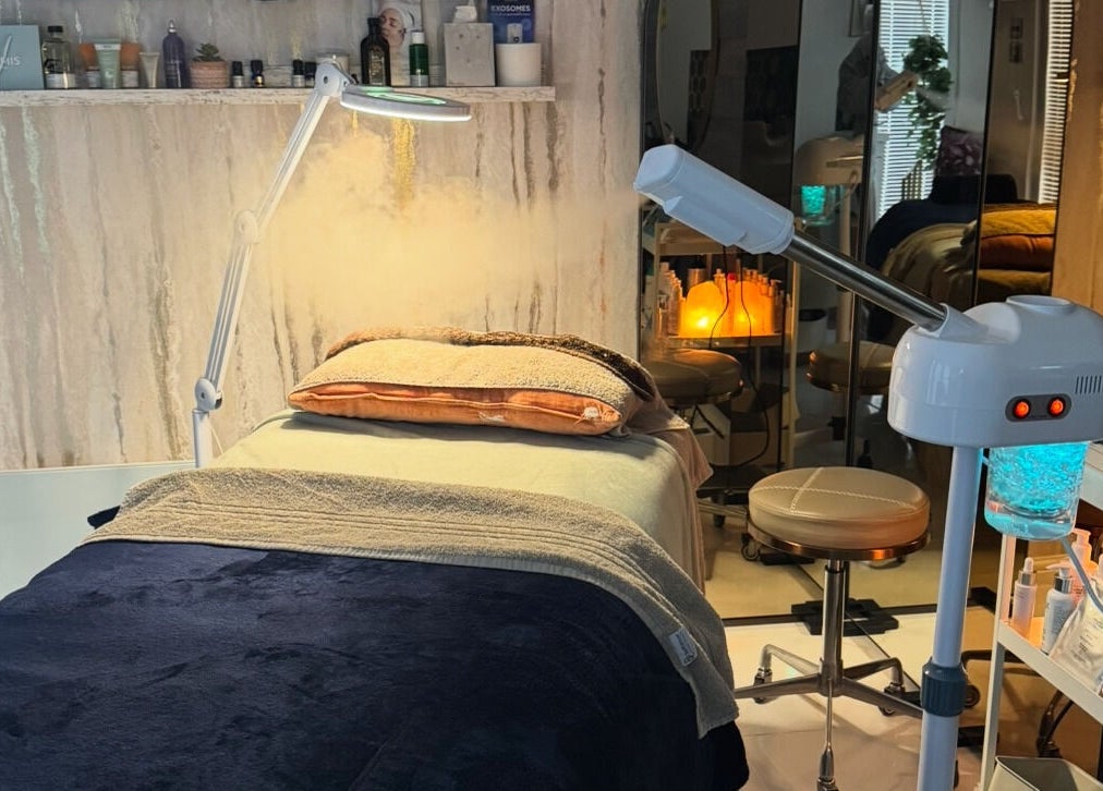 Relaxing spa treatment room at Green Ivy Skin And Spa, Barton Seagrave, England, GB with cozy bedding and equipment.