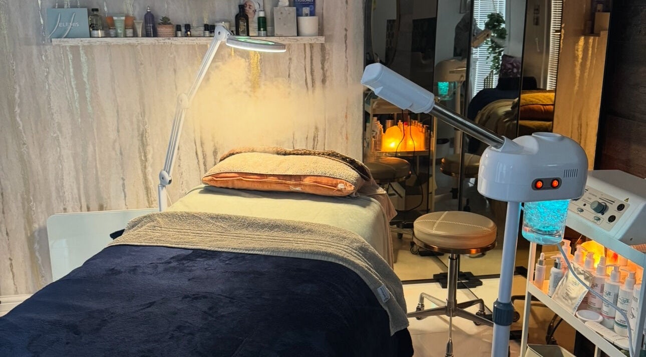 Relaxing spa treatment room at Green Ivy Skin And Spa, Barton Seagrave, England, GB with cozy bedding and equipment.