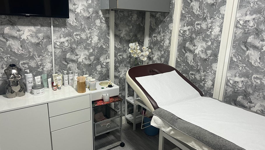 Beauty by Jen's serene treatment room, Liverpool, England, GB, showcasing spa essentials and decor.