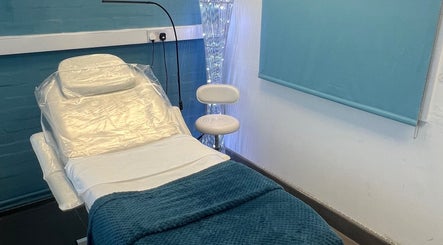Cozy treatment room at Beauty by Jen, Liverpool, England, GB with a comfortable chair and ambient lighting.