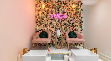 Luxurious floral wall and pink seating at WINK Beauty in London, England, GB offer a relaxing ambiance.