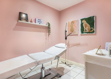 Peaceful treatment room at WINK Beauty, London, England, GB with a pink decor and modern amenities.