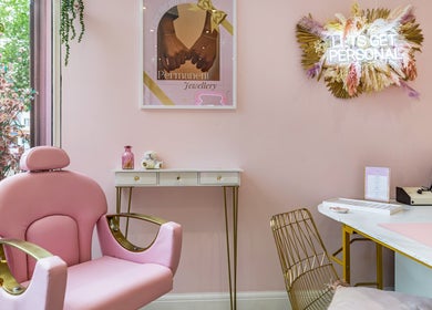 Elegant pink salon chair at WINK Beauty, London, England, GB. Feminine decor enhances relaxing ambiance.
