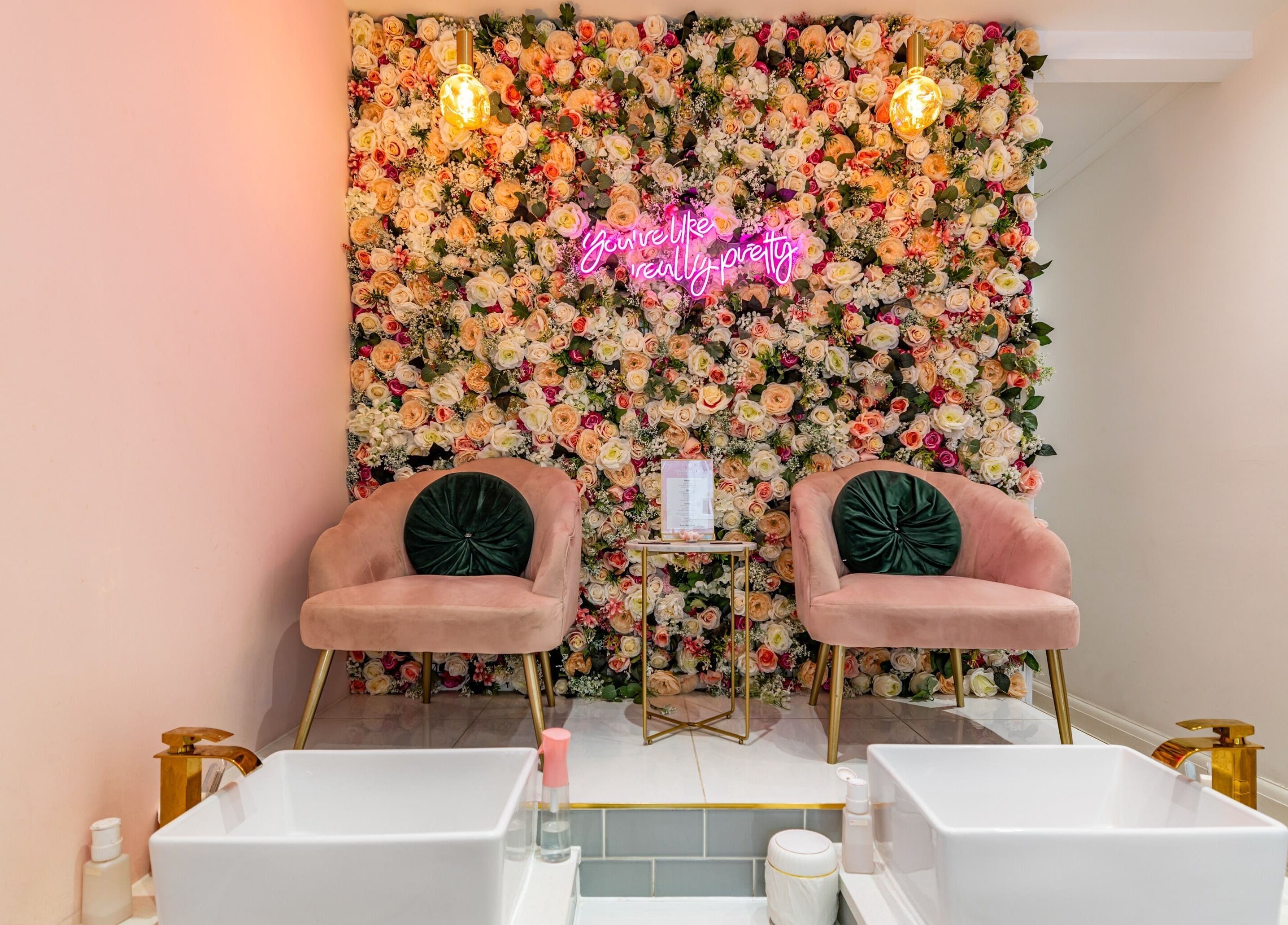 Chic floral wall with chairs at WINK Beauty - Whetstone, London, England, GB, offering a serene ambiance.