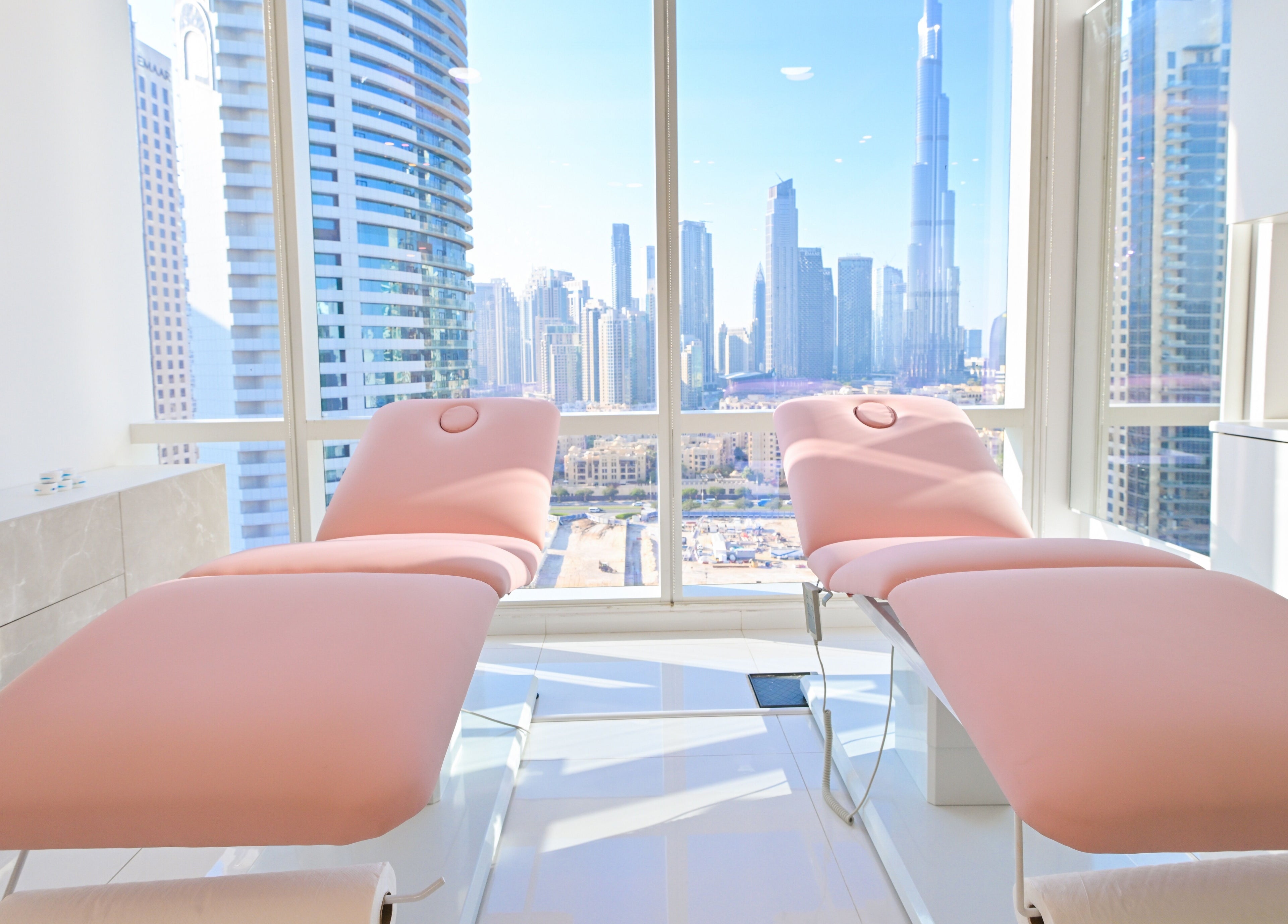 Modern treatment room at Snatch & Glow London in Dubai, Dubai, AE, with stunning skyline view.