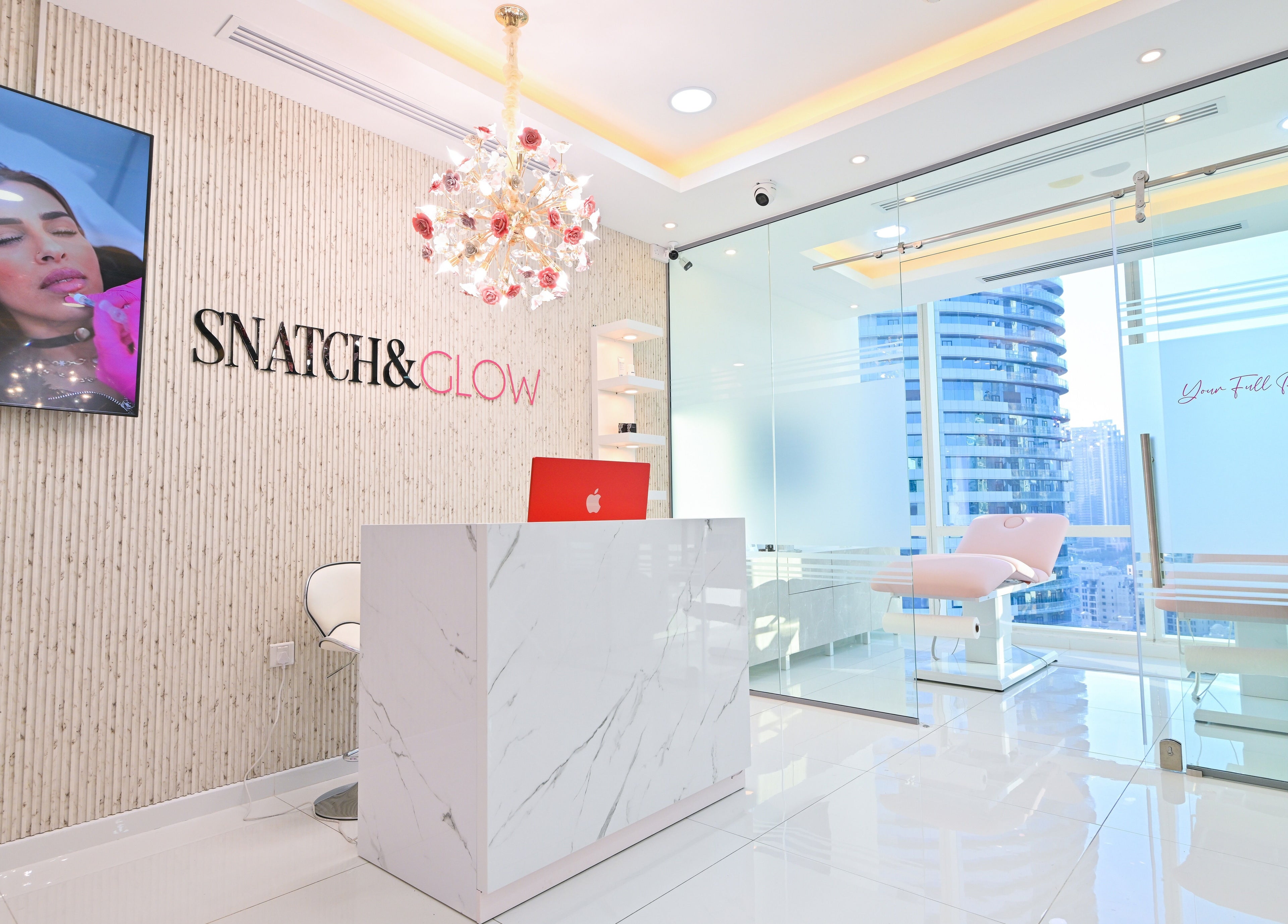 Reception area of Snatch & Glow London in Dubai, Dubai, AE with modern decor and city views.