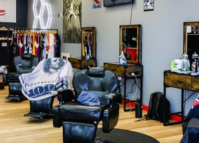 Stylish barber chairs at Kicks And Fades Barbering Co in Idaho Falls, Idaho, US, with vibrant decor.