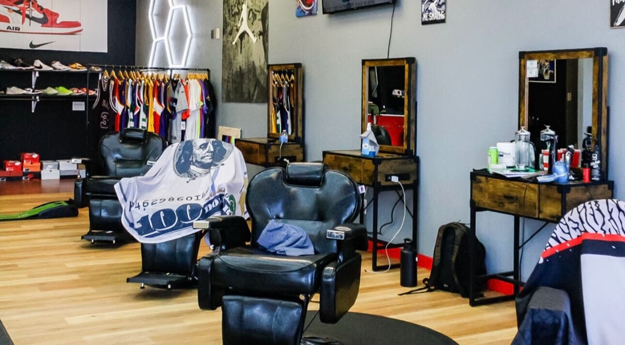 Stylish barber chairs at Kicks And Fades Barbering Co in Idaho Falls, Idaho, US, with vibrant decor.