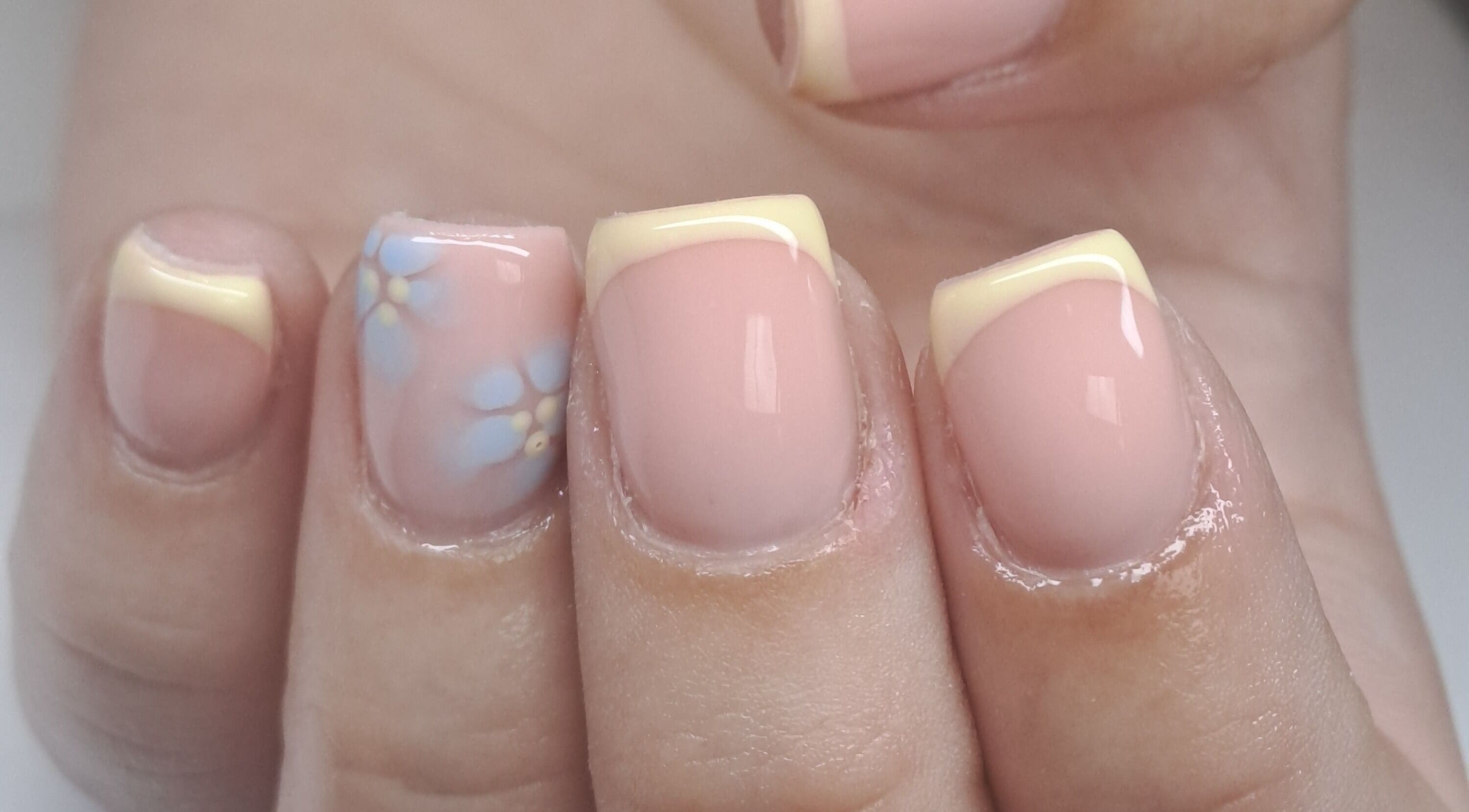 Elegant nail art featuring French tips and floral design at Sculpted by Sarah, County Louth, County Louth, IE.