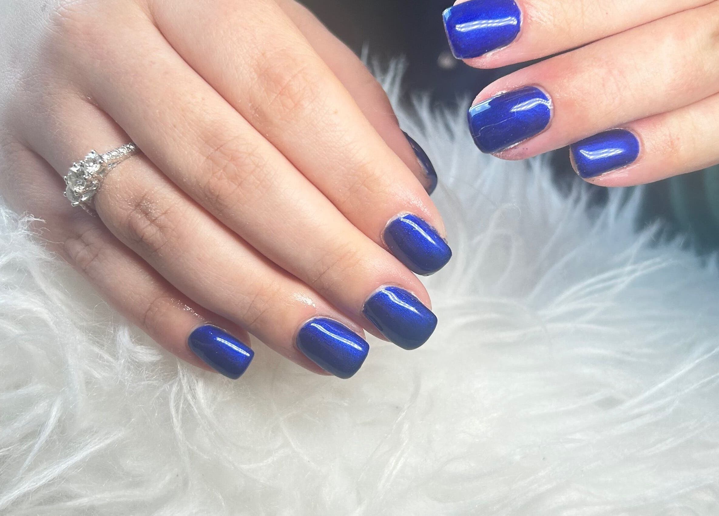 Elegant sapphire nails with a ring at The Glamour Room, Gorey, County Wexford, IE.