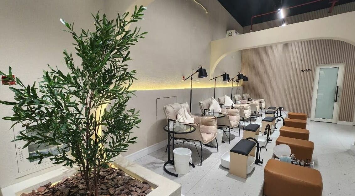 Elegant pedicure lounge at Malath Beauty Center, Kalba, Sharjah, AE, featuring plush seating and ambient lighting.