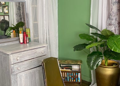 Cozy corner at Stylin' Chic by Auldine's, Kingstown, St. George, VC with elegant decor and vibrant plants.