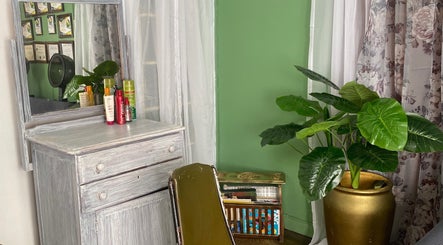 Cozy corner at Stylin' Chic by Auldine's, Kingstown, St. George, VC with elegant decor and vibrant plants.