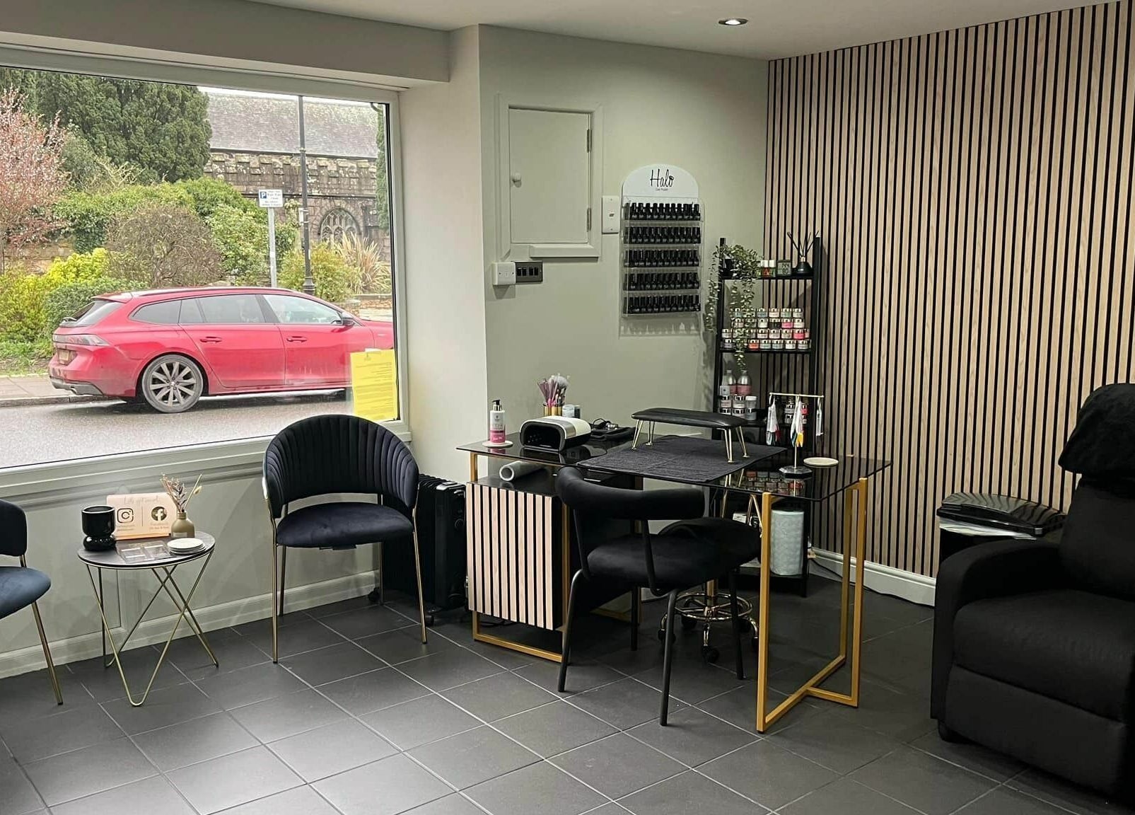 Modern salon interior at Ells Hair and Nails in Callington, England, GB with elegant seating and nail station.